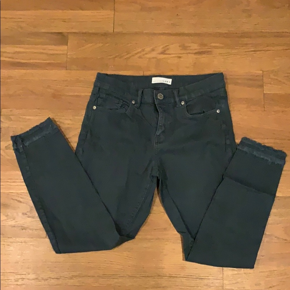 Turquoise jeans with frayed bottom